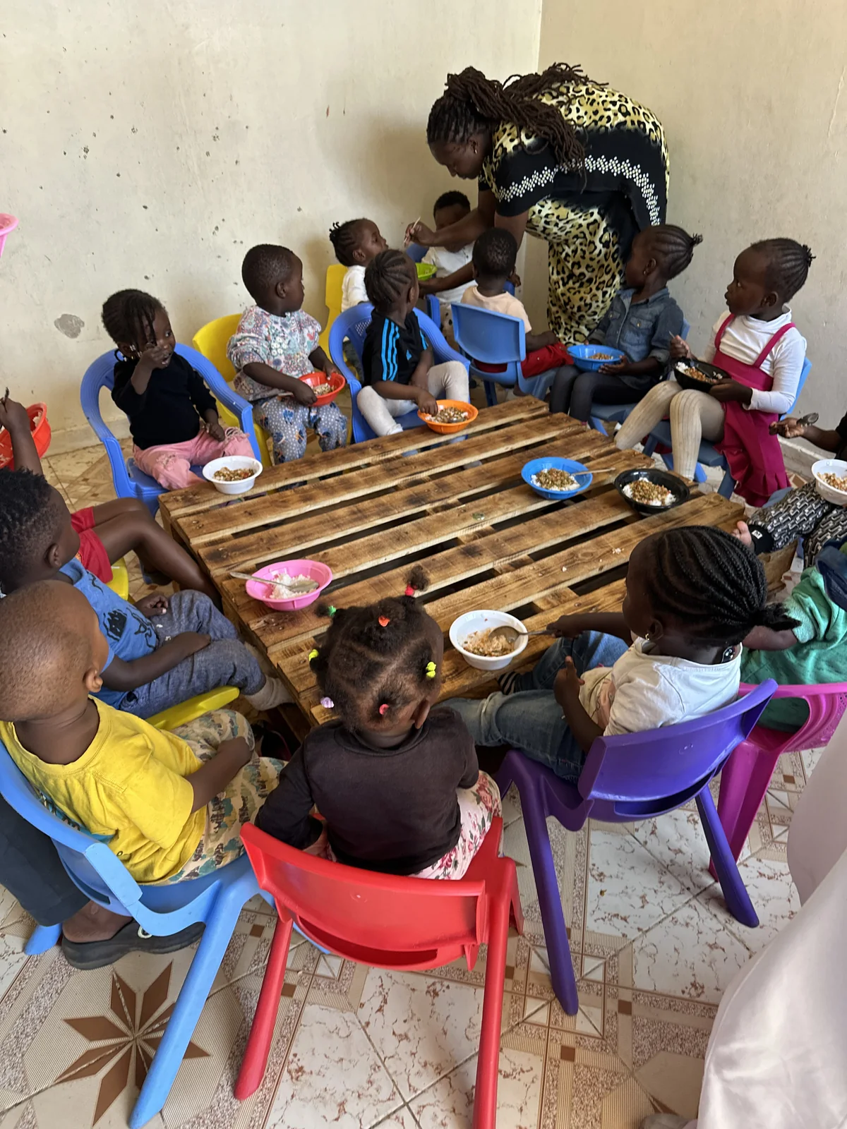 Children enjoying a shared meal outdoors
